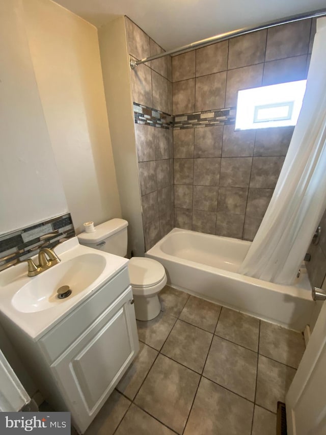 full bathroom featuring tile flooring, toilet, vanity, and shower / bath combo