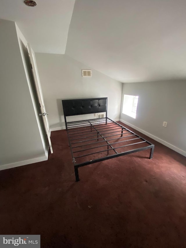 unfurnished bedroom featuring dark colored carpet