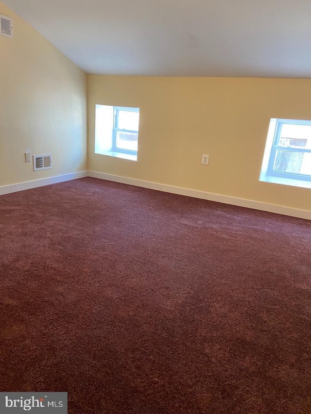 unfurnished room with dark carpet