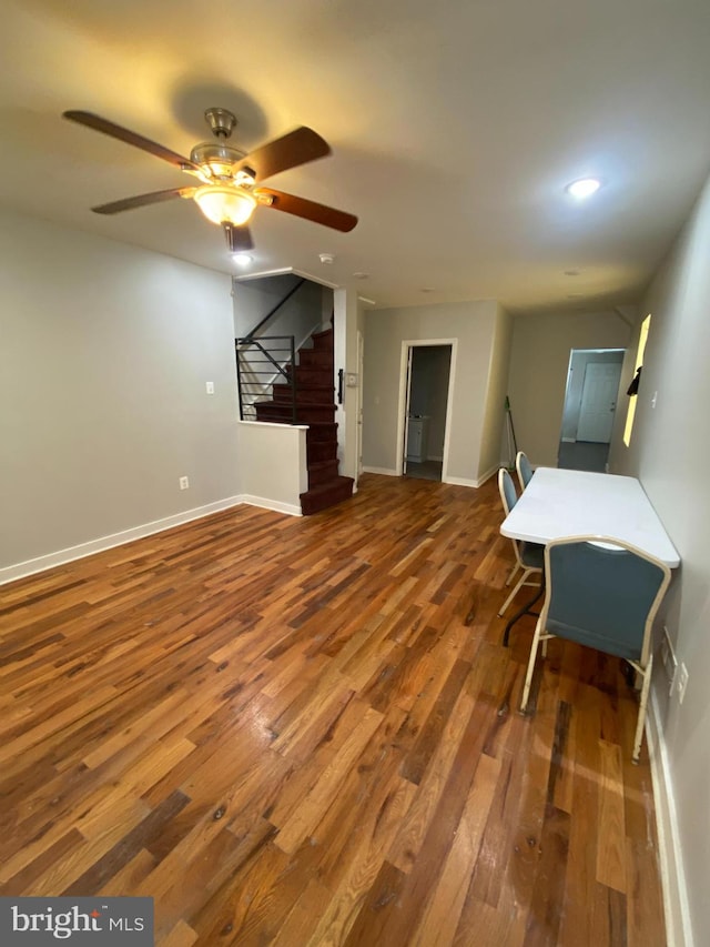 interior space with ceiling fan and dark hardwood / wood-style floors