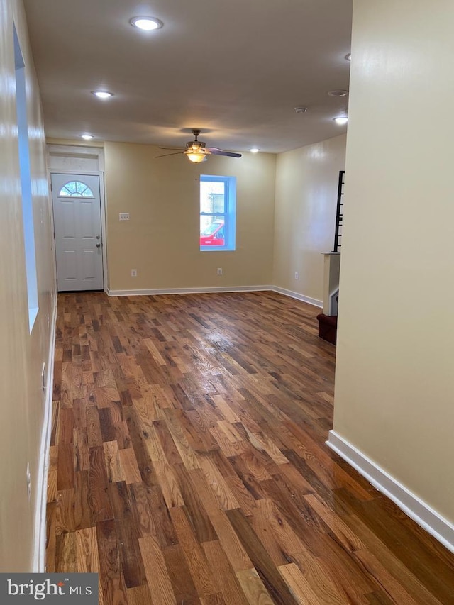 unfurnished room with dark hardwood / wood-style floors and ceiling fan