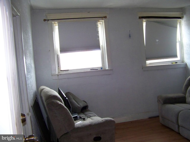 living area with hardwood / wood-style flooring