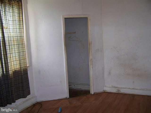 unfurnished bedroom featuring hardwood / wood-style flooring