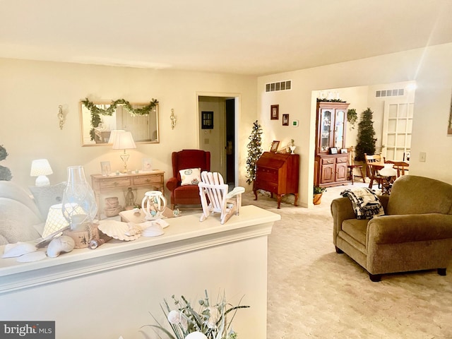 living room featuring visible vents and light colored carpet