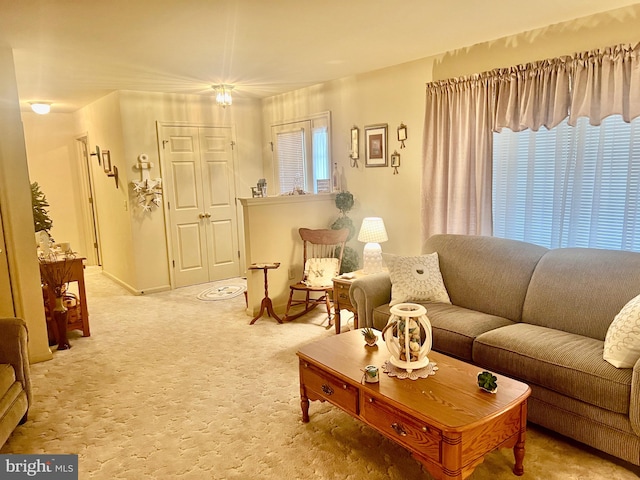 carpeted living room with baseboards