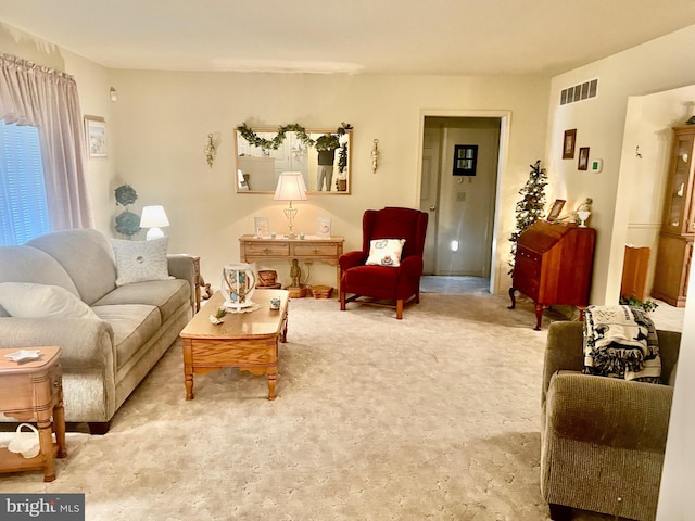 living area featuring visible vents and light colored carpet