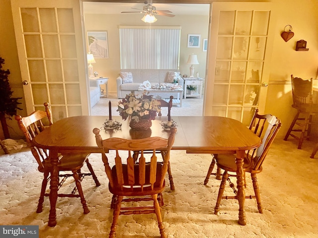 dining room with ceiling fan and carpet flooring