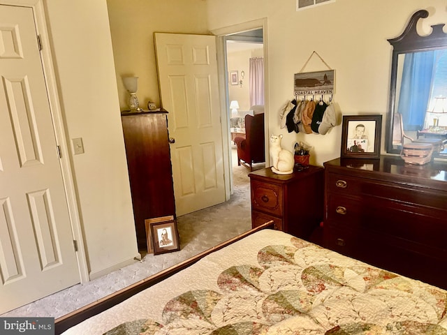 bedroom with visible vents and light colored carpet