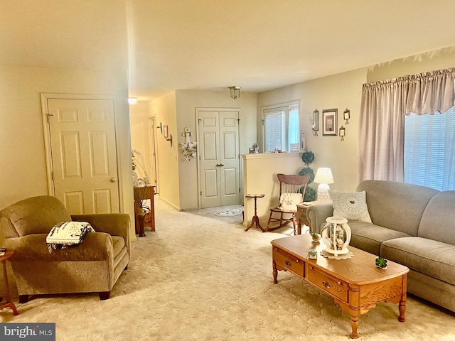 living room featuring light colored carpet and baseboards