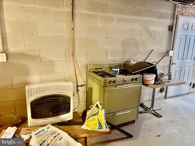 details featuring concrete block wall, concrete floors, and heating unit