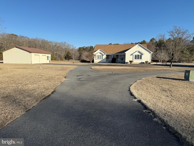 view of front of home with a garage and an outdoor structure