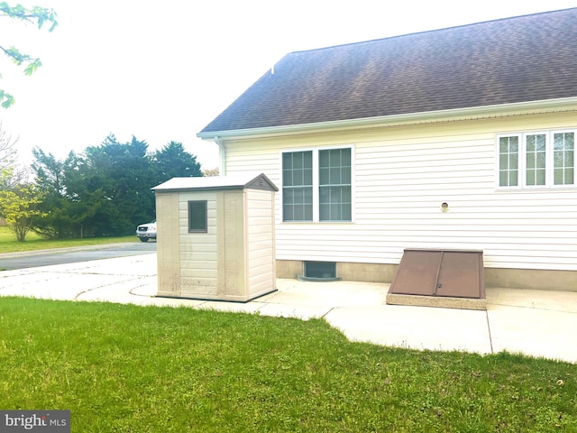 rear view of property with a yard and roof with shingles