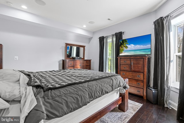 bedroom with dark wood-type flooring