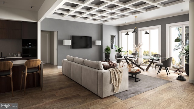 living room with ornamental molding, light hardwood / wood-style flooring, and coffered ceiling