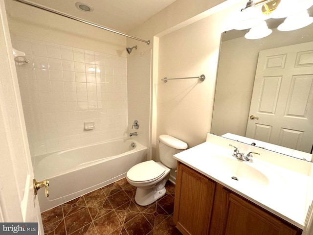 full bathroom featuring tiled shower / bath, vanity, toilet, and tile patterned flooring