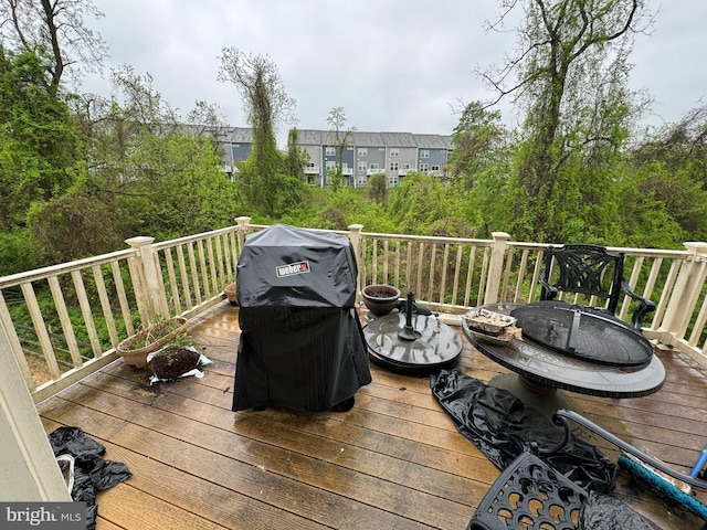 wooden deck with a grill