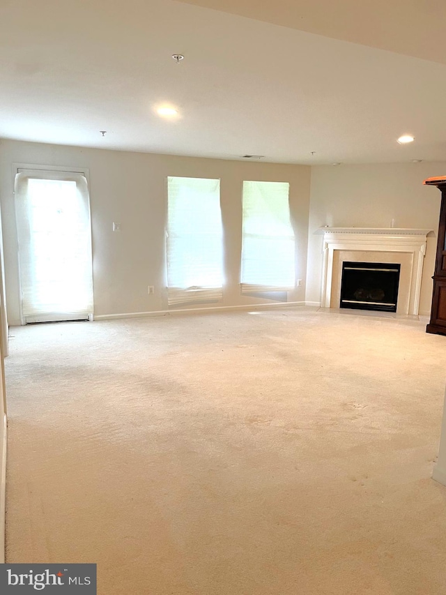 unfurnished living room featuring light colored carpet