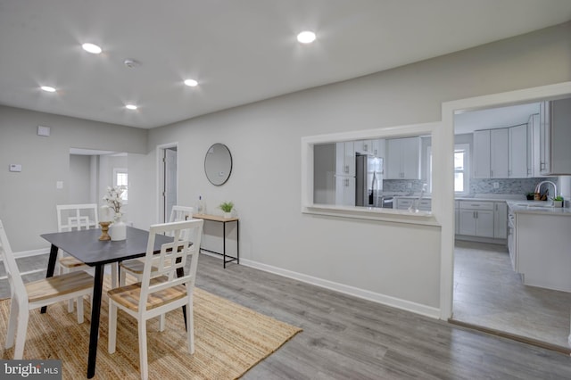 dining space featuring light hardwood / wood-style flooring and sink