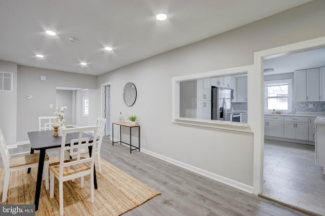 dining room with light wood-type flooring and sink