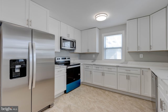 kitchen featuring white cabinetry, light stone countertops, and appliances with stainless steel finishes