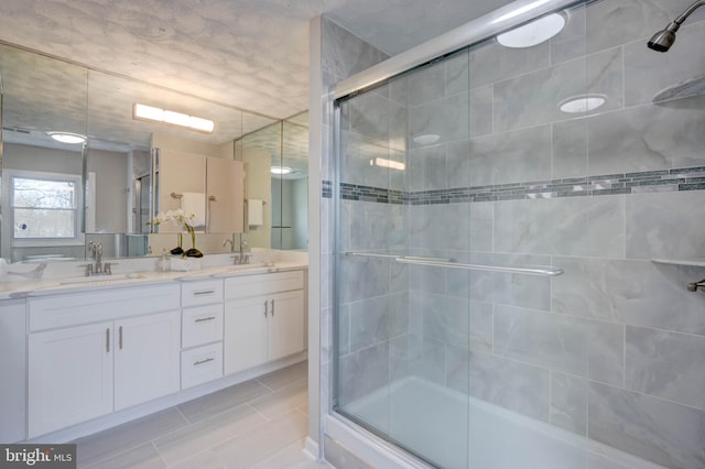 bathroom featuring vanity and an enclosed shower