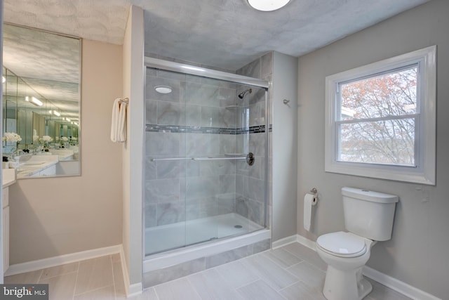 bathroom with tile patterned floors, vanity, toilet, and an enclosed shower