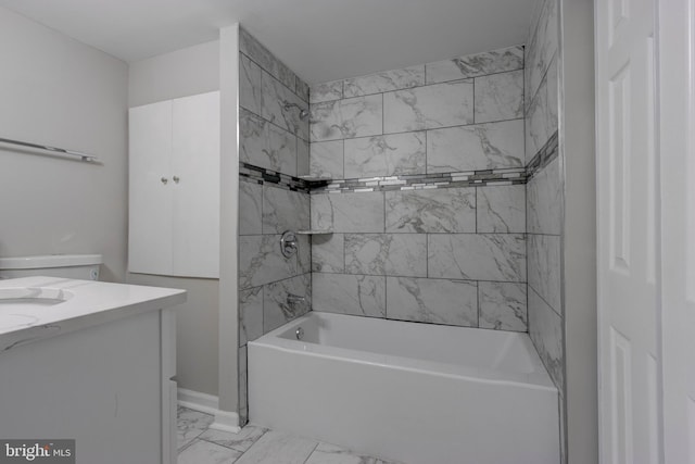 bathroom with vanity and tiled shower / bath