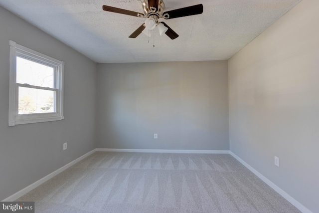 carpeted empty room featuring a textured ceiling and ceiling fan