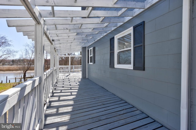 wooden deck featuring a water view