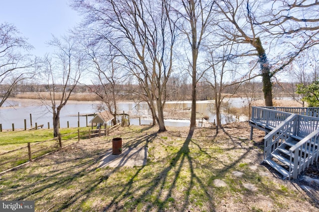 view of yard featuring a deck with water view