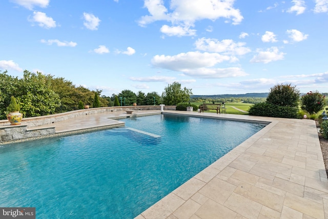 view of swimming pool featuring a patio area