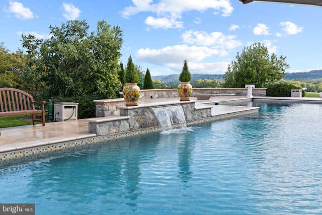 view of pool featuring a patio and pool water feature