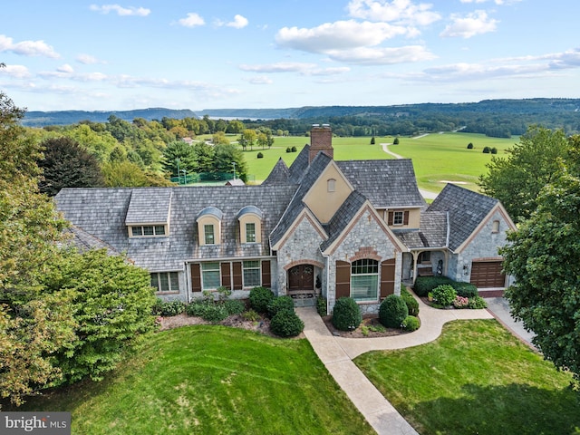 french country inspired facade featuring a front yard