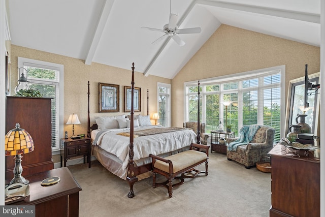 bedroom with beamed ceiling, high vaulted ceiling, ceiling fan, and light carpet