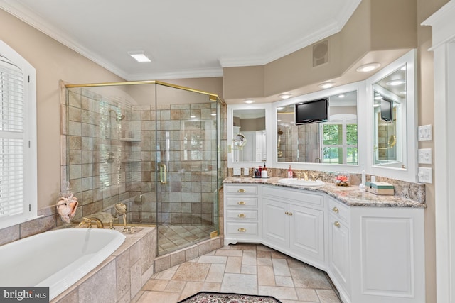 bathroom with tile flooring, vanity with extensive cabinet space, crown molding, and plus walk in shower