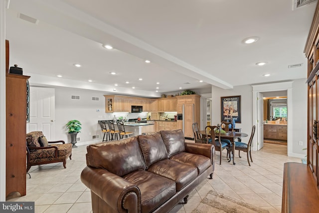 tiled living room with beamed ceiling