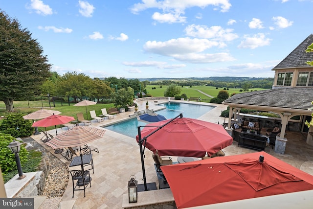 view of swimming pool with a patio area and a yard