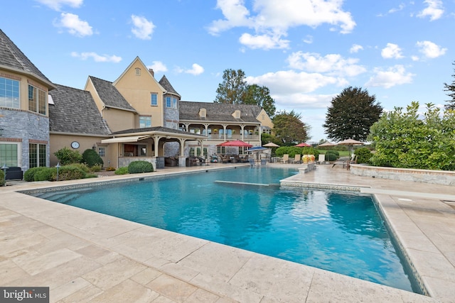 view of swimming pool featuring a patio area and a gazebo