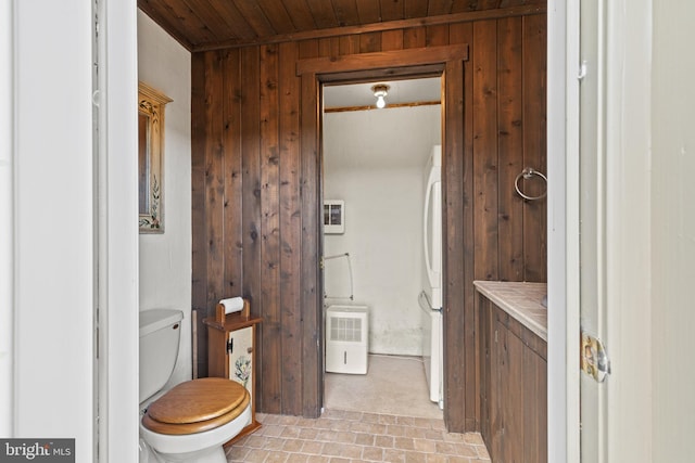 bathroom with wood ceiling, wood walls, and toilet