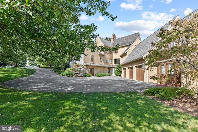 exterior space with a front lawn and a garage