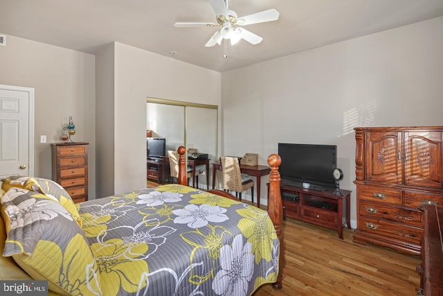 bedroom featuring light wood-type flooring, a closet, and ceiling fan