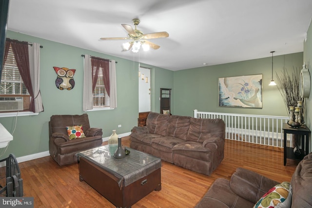 living room with hardwood / wood-style flooring, ceiling fan, and cooling unit