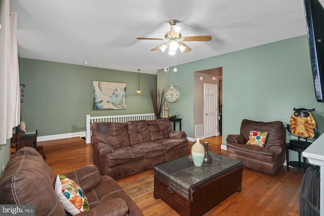 living room with ceiling fan and hardwood / wood-style floors