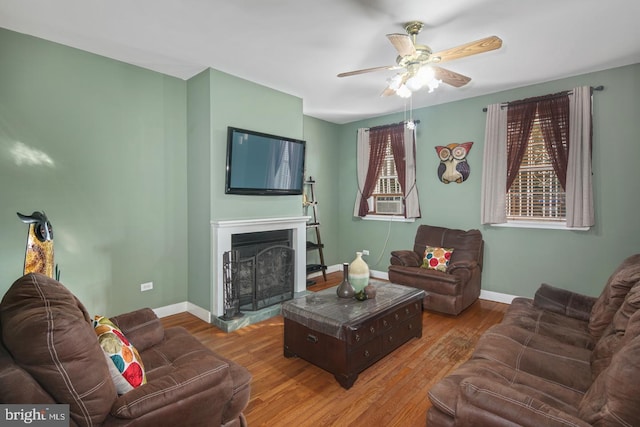 living room with light wood-type flooring and ceiling fan