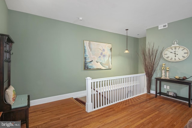 interior space featuring hardwood / wood-style floors and a crib