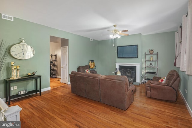 living room with light hardwood / wood-style floors and ceiling fan