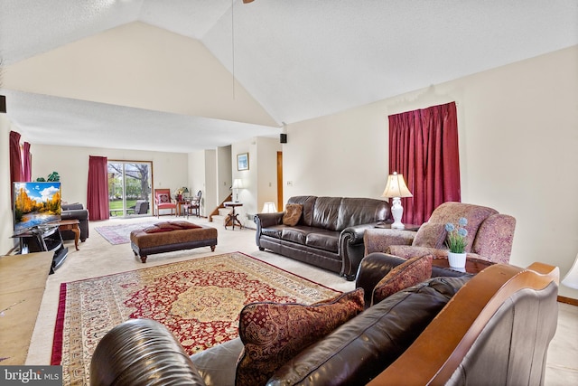 living room with light carpet, high vaulted ceiling, and a textured ceiling