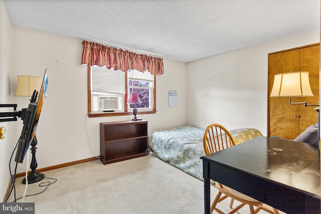 carpeted bedroom featuring a textured ceiling