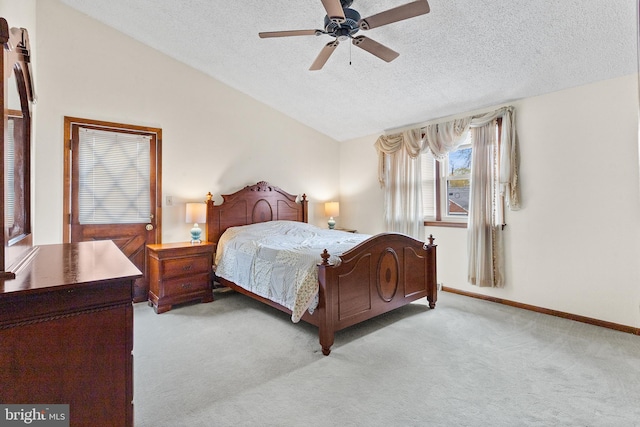 bedroom featuring a textured ceiling, ceiling fan, and light carpet