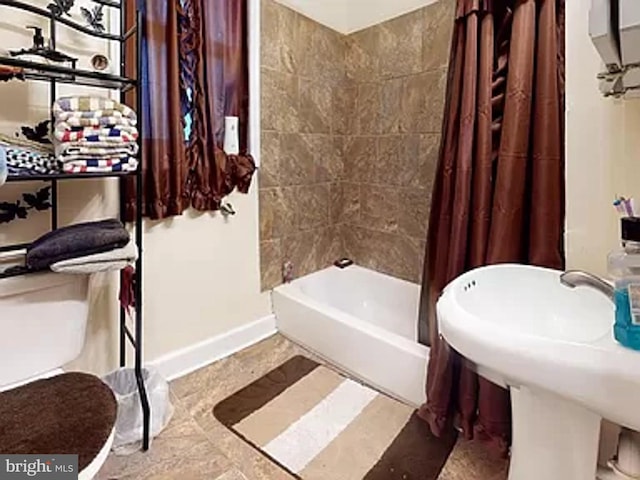 bathroom featuring shower / tub combo with curtain and tile flooring